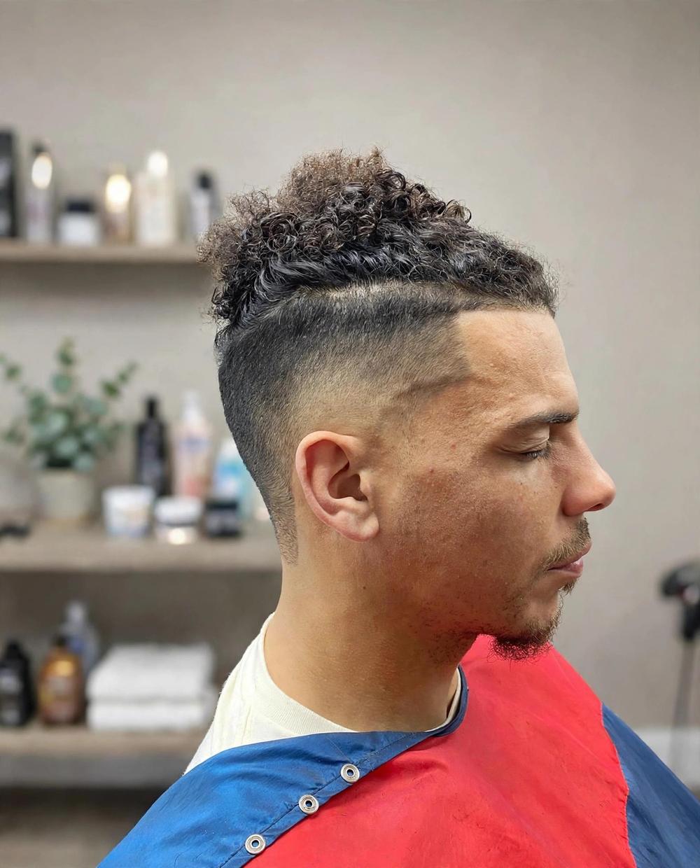 A curly top fade cut at Str8-Edge
